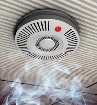 Illustration of a smoke and fire detector in rising smoke at a gray ceiling