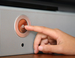 Image of finger pushing power button.